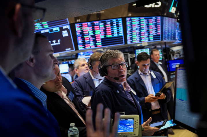 Traders work on the floor of the NYSE in New York