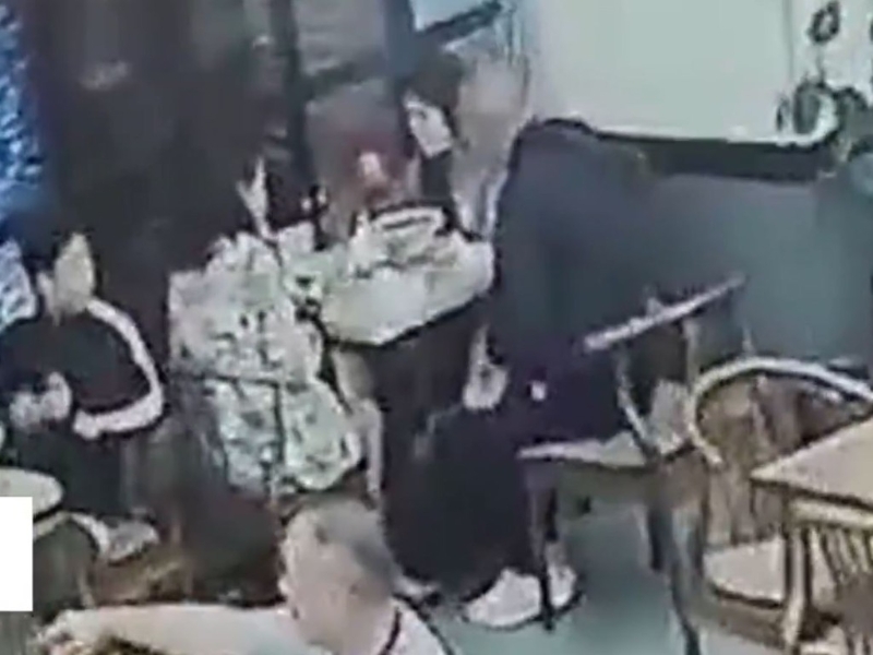 黑衣男坐下与两名女子交谈。 黑衣男坐下与两名女子交谈。