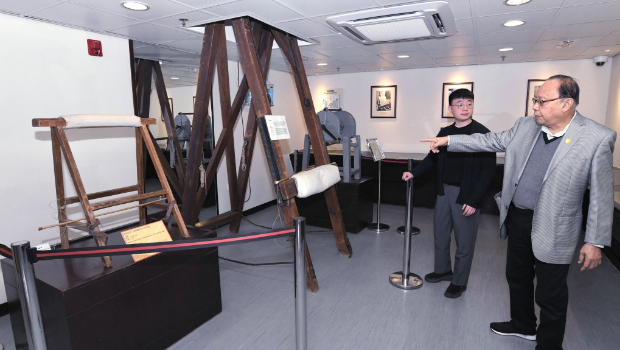 香港惩教博物馆助理馆长马祺俊(左)及博物馆助理李钰麟(右)介绍馆内的大型笞刑架。 香港惩教博物馆助理馆长马祺俊(左)及博物馆助理李钰麟(右)介绍馆内的大型笞刑架。