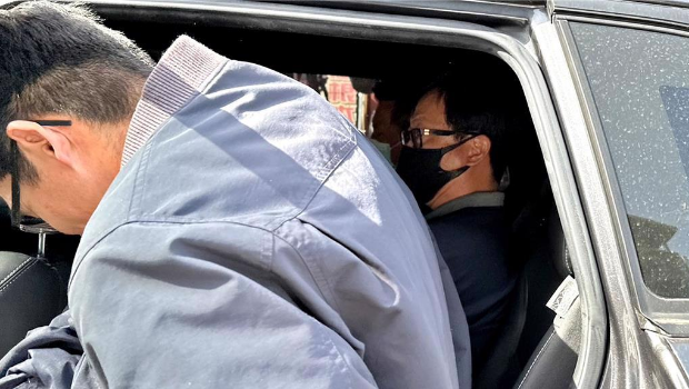 三重区党部执行长罗大宇(右)带回侦讯。 三重区党部执行长罗大宇(右)带回侦讯。