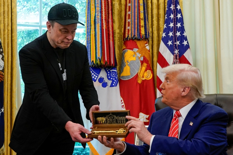 美国总统特朗普30日在白宫欢送马斯克,以金钥匙相赠。 美国总统特朗普30日在白宫欢送马斯克,以金钥匙相赠。