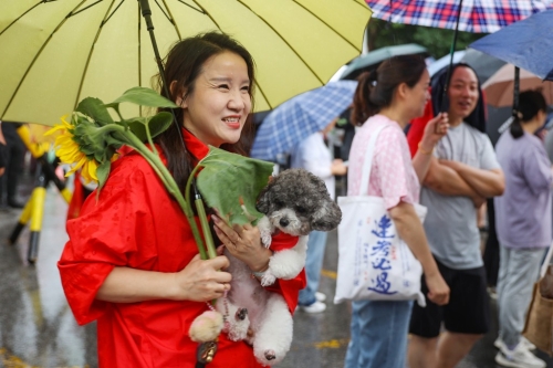 南京的家长带向日葵送考望“一举夺魁”。 中新社 南京的家长带向日葵送考望“一举夺魁”。 中新社