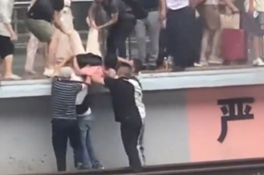 郴州男子家事争执跳高铁轨,3乘客协助对方家人,将跳轨男抬起救回。 郴州男子家事争执跳高铁轨,3乘客协助对方家人,将跳轨男抬起救回。