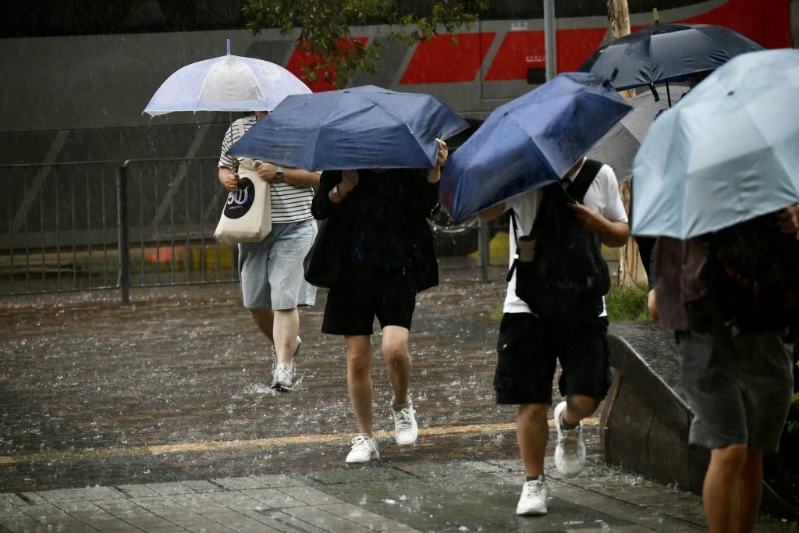 不少巿民冒着黑雨上班。 不少巿民冒着黑雨上班。