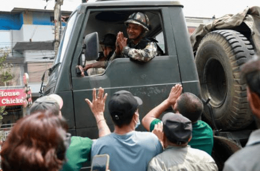 军队经过时与示威者互相致意。 军队经过时与示威者互相致意。